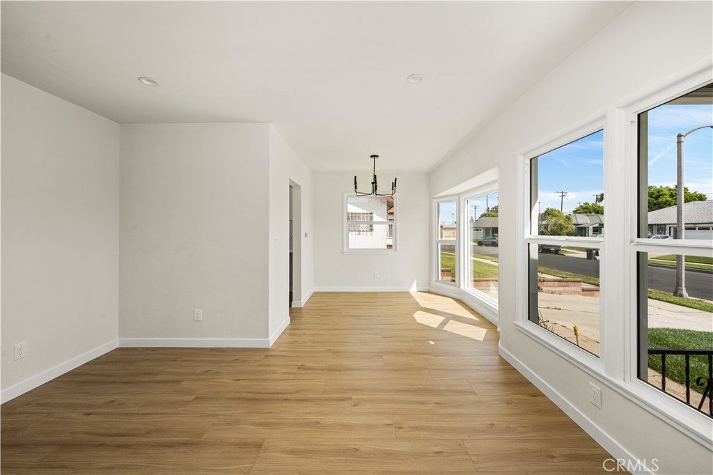 1013 West 138th Street Compton, CA 90222 - Photo 8 of 30 a view of empty room with wooden floor and fan