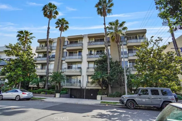 a front view of a building with trees