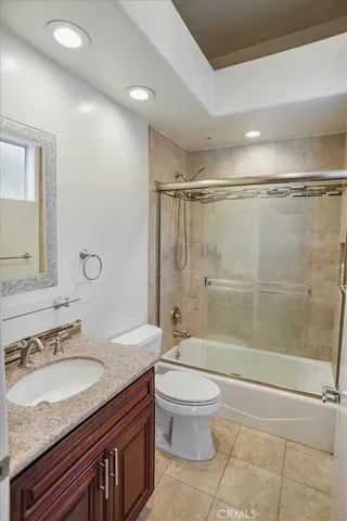 a spacious bathroom with a tub sink and mirror