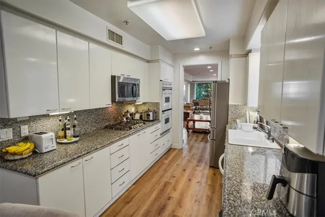 a spacious bathroom with a double vanity sink a mirror and a bathtub