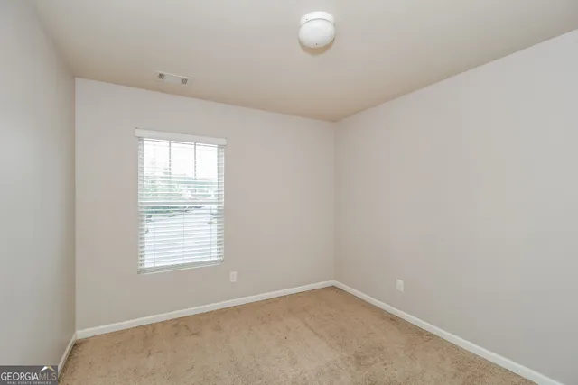 a view of a room with window and closet area