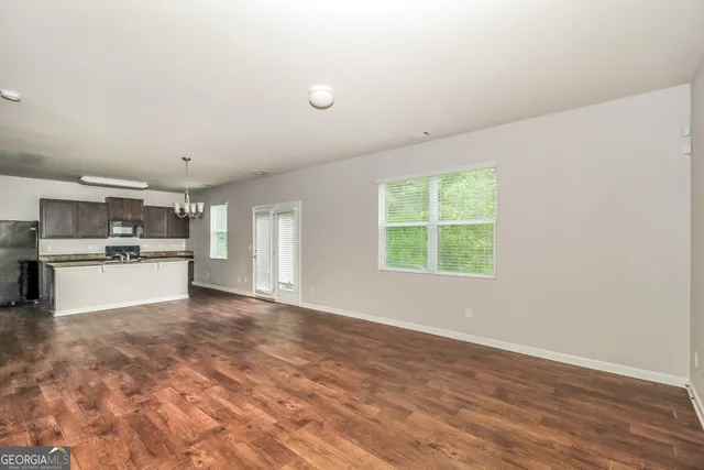a view of kitchen with refrigerator and window