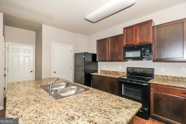 a kitchen with a sink stove and refrigerator