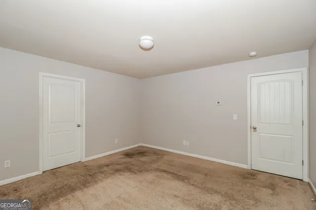 a bathroom with a sink double vanity granite tub and a mirror