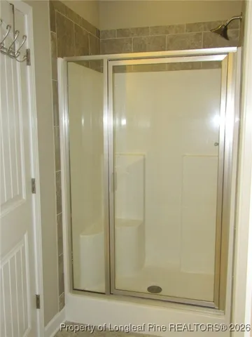 a bathroom with a glass shower door