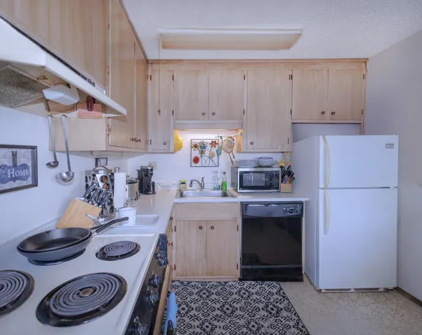 a kitchen with a stove and white cabinets