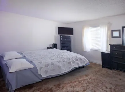 a bedroom with a bed and a dresser