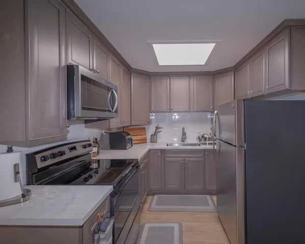 a kitchen with a refrigerator stove and microwave