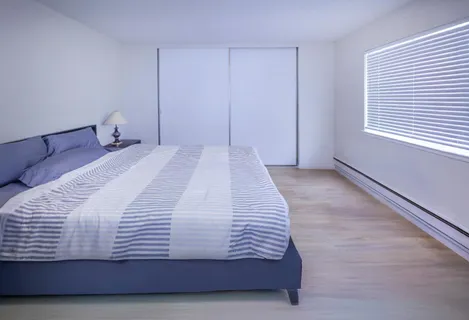 a bedroom with a bed and window