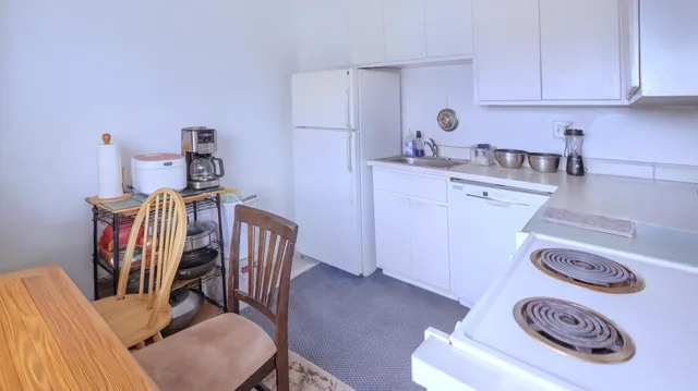 a kitchen with a table chairs and a stove