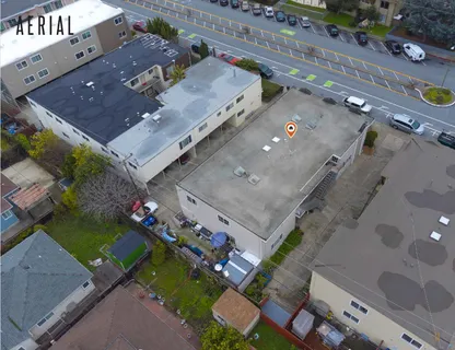 an aerial view of a house with a yard