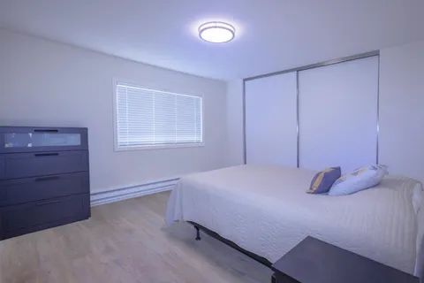 a bedroom with a bed and window