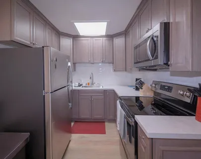 a kitchen with a stove sink and refrigerator