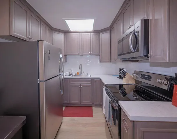 a kitchen with a stove sink and refrigerator