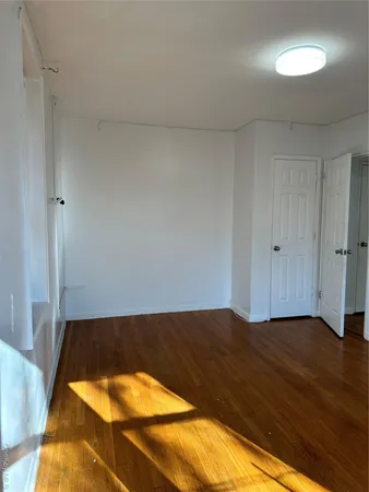 a view of a room with wooden floor
