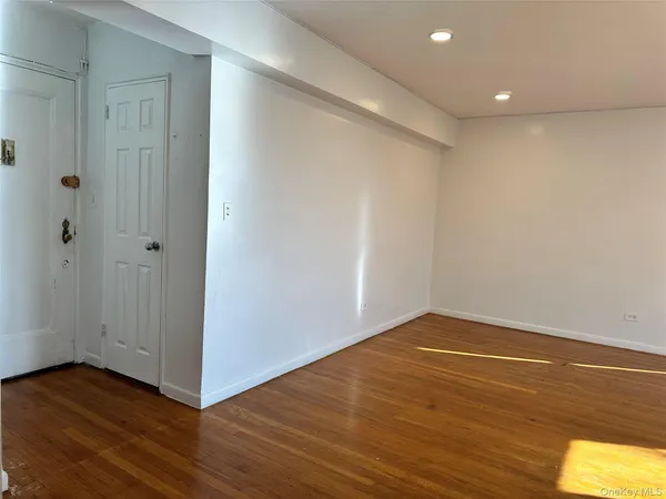 a view of a room with wooden floor