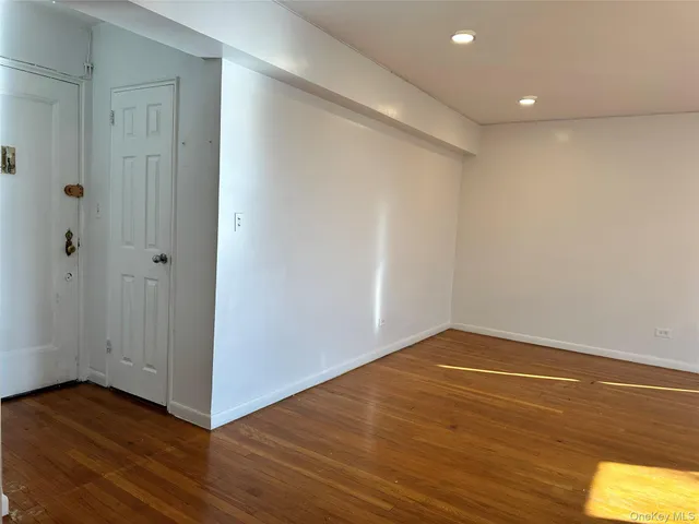 a view of a room with wooden floor