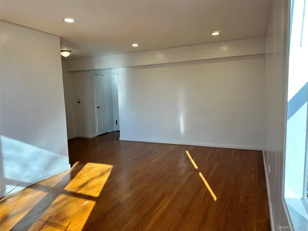 a view of a room with wooden floor