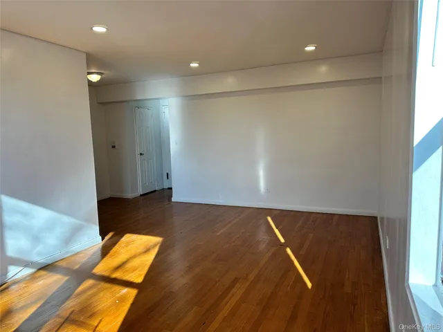a view of a room with wooden floor