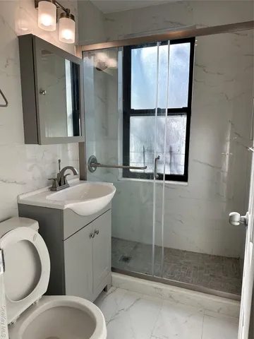 a bathroom with a toilet sink and mirror