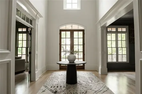 a living room with furniture a flat screen tv and a large window