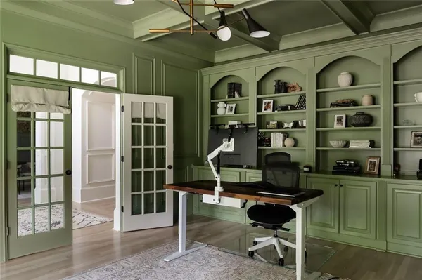 a dining room with furniture a chandelier and wooden floor