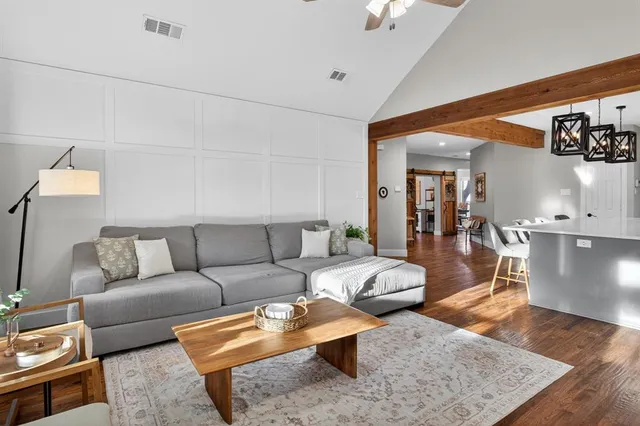 a living room with furniture and wooden floor
