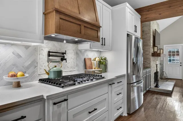 a kitchen with stainless steel appliances granite countertop a stove and a refrigerator
