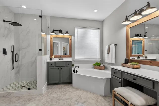 a bathroom with a tub sink and mirror