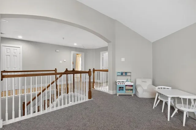 a view of a hallway with seating area