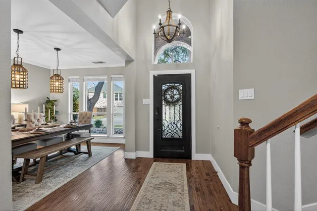a view of an entryway with wooden floor and a front door