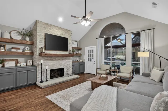 a living room with furniture a fireplace and a flat screen tv