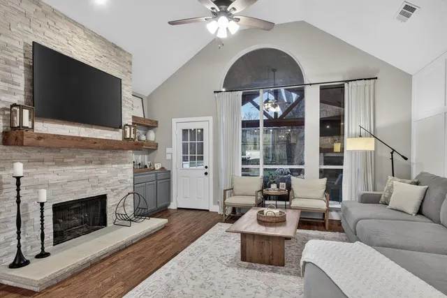 a living room with furniture a fireplace and a flat screen tv