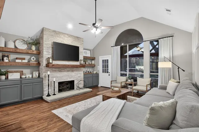 a living room with furniture a fireplace and a flat screen tv