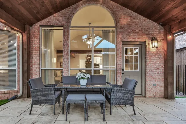 a view of a chair and table in backyard of the house
