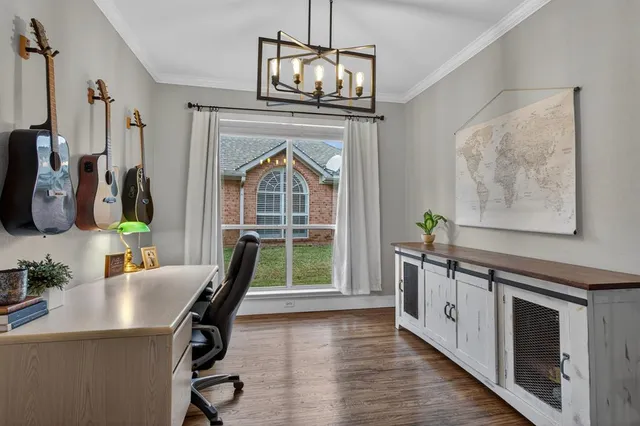 a view of a dining room with furniture a chandelier and wooden floor