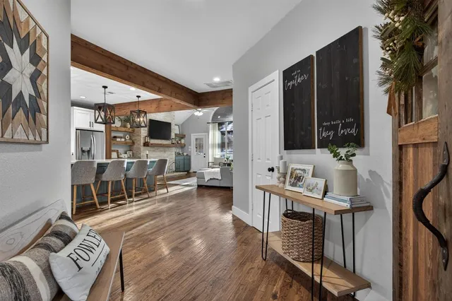 a living room with furniture a flat screen tv and a floor to ceiling window