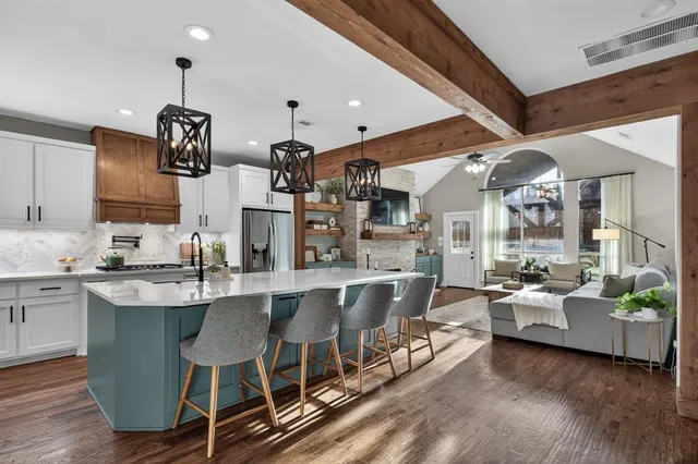 a large kitchen with a table and chairs