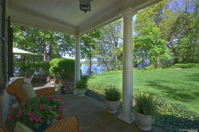 a view of a porch with furniture and garden