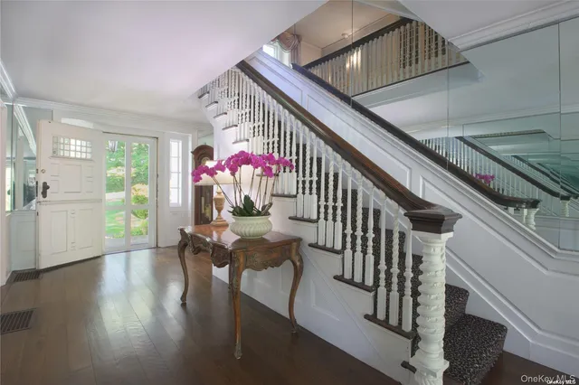 a living room with furniture and floor to ceiling windows