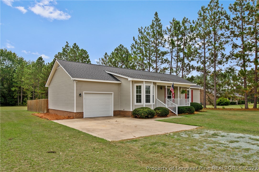 2064 Bainbridge Road Stedman, NC 28391 - Photo 3 of 43 a front view of house with yard and green space