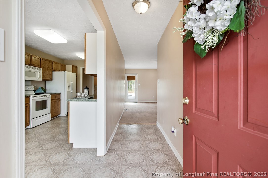 2064 Bainbridge Road Stedman, NC 28391 - Photo 5 of 43 a view of a hallway with wooden floor