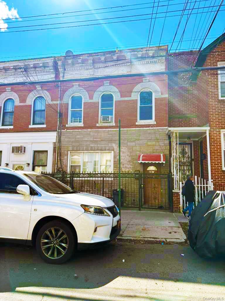 a front view of a building with parking space