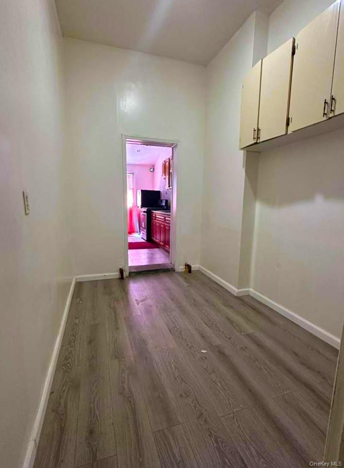 88-22 85th Street Queens, NY 11421 - Photo 11 of 39 a view of a room with wooden floor and cabinets