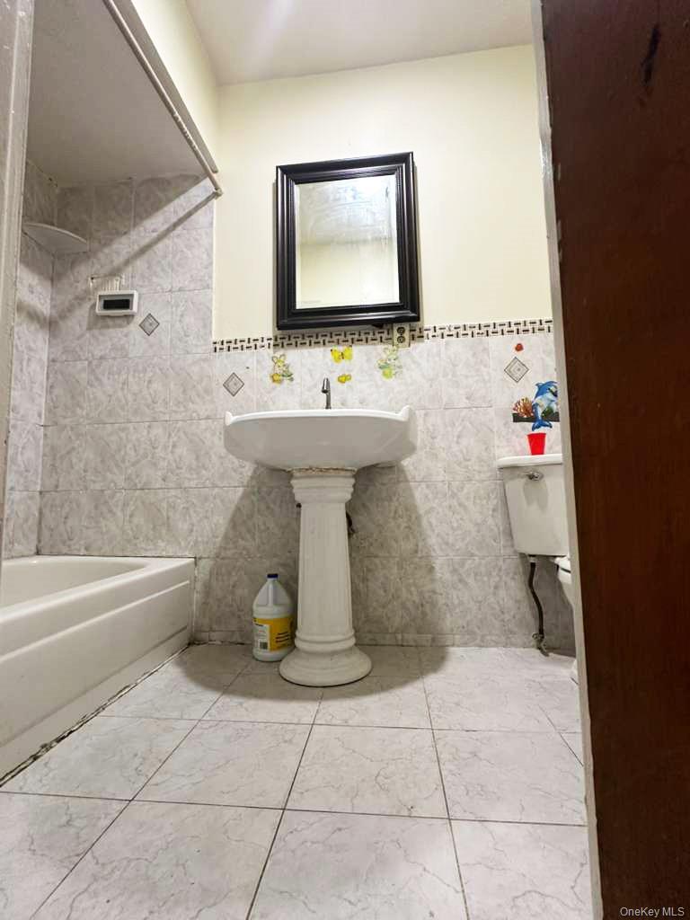 88-22 85th Street Queens, NY 11421 - Photo 13 of 39 a bathroom with a sink toilet and shower