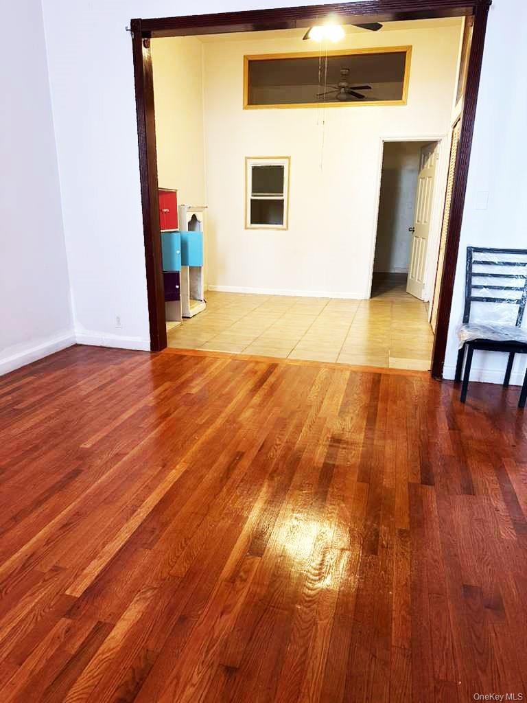 88-22 85th Street Queens, NY 11421 - Photo 22 of 39 a view of a livingroom with wooden floor and staircase