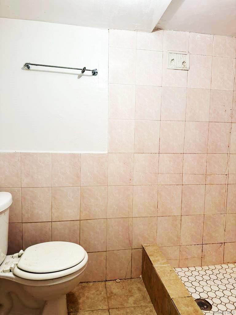 88-22 85th Street Queens, NY 11421 - Photo 29 of 39 a bathroom with a toilet and a shower