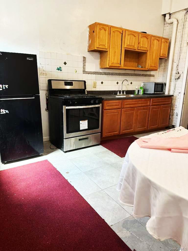 88-22 85th Street Queens, NY 11421 - Photo 37 of 39 a kitchen with a sink and cabinets