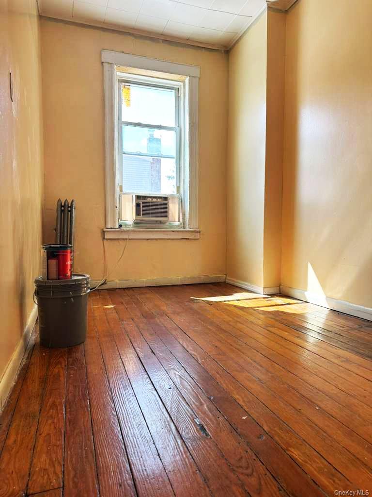 88-22 85th Street Queens, NY 11421 - Photo 9 of 39 a view of a room with wooden floor and windows