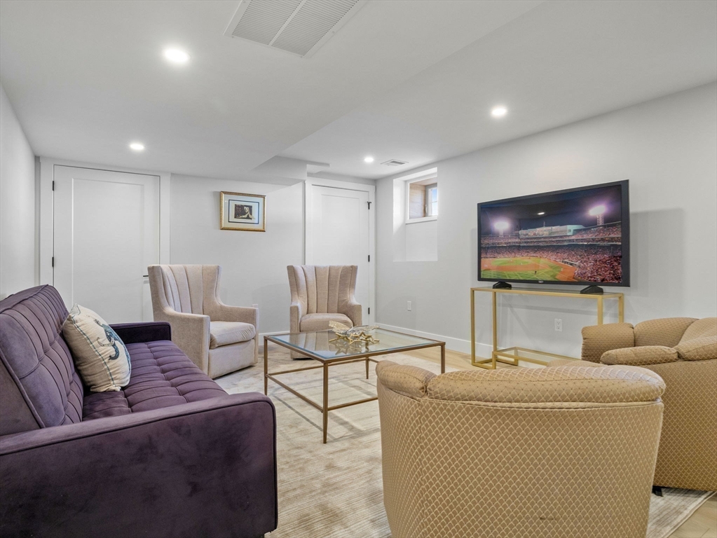 58 Townly Road Watertown, MA 02472 - Photo 35 of 42 a living room with furniture and a flat screen tv
